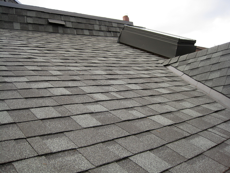 IKO Cambridge asphalt shingles in harvard slate colour installed on a main roof and around a multi-window dormer on flat roof section in Seaton Village, Toronto.